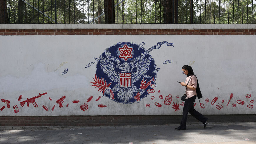 A woman walks past an anti-US mural on a street in Tehran, Iran, June 5, 2025. Majid Asgaripour/WANA (West Asia News Agency) via REUTERS
