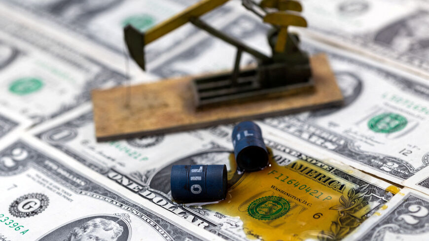 FILE PHOTO: Oil, miniatures of oil barrels, oil pump jack and U.S. dollar banknote are seen in this illustration taken, June 6, 2023. REUTERS/Dado Ruvic/Illustration/File Photo