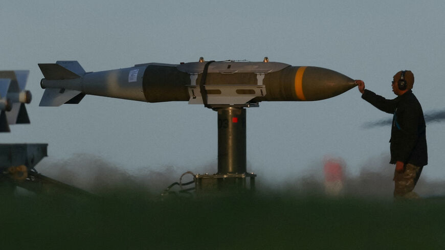 A member of ground crew moves munitions towards a USAF B1 B bomber at RAF Fairford airbase, used by USAF personnel, amid the U.S.–Israeli conflict with Iran, in Fairford, Gloucestershire, Britain, March 11, 2026. REUTERS/Phil Noble