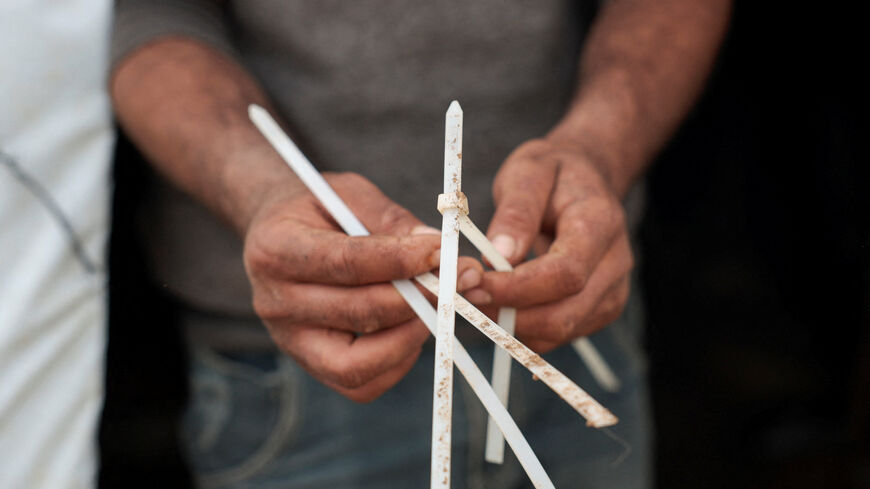 Suhaib Abu Kbash holds zip ties used during an attack by Israeli settlers on his community, in a Palestinian Bedouin encampment in the Jordan Valley, in the Israeli‑occupied West Bank, March 19, 2026. REUTERS/Mohammed Torokman