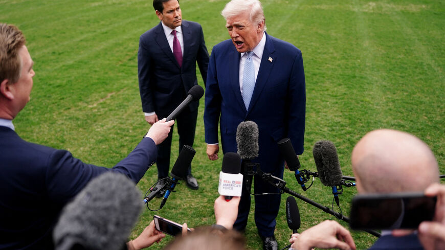 U.S. President Donald Trump speaks to the media, flanked by U.S. Secretary of State Marco Rubio, as he departs the White House for Florida, in Washington, D.C., U.S., March 20, 2026. REUTERS/Nathan Howard