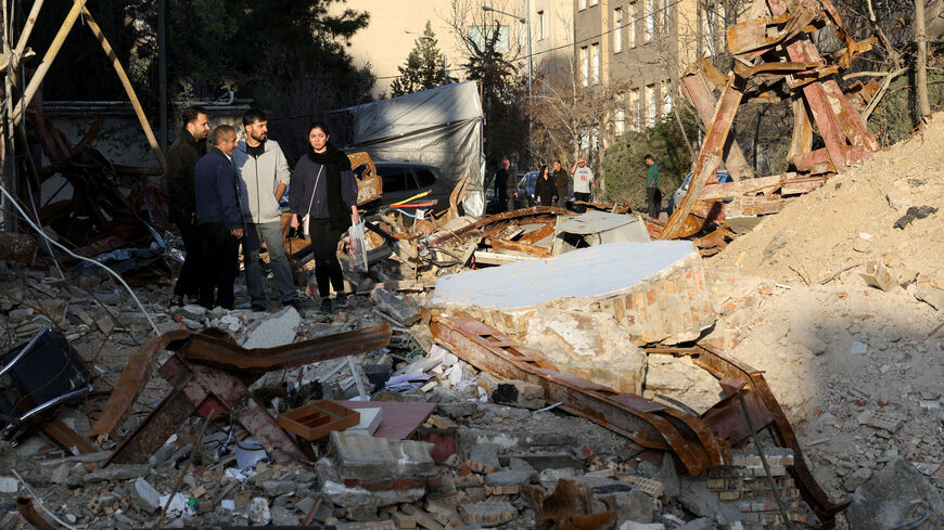 People look at a destroyed building following a strike, amid the U.S.-Israeli conflict with Iran, in Tehran, Iran, March 21, 2026. Reuters/Alaa Al-Marjani
