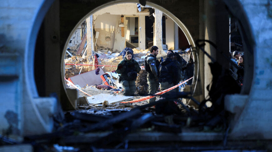 Security personnel work at the site of damage after Iranian missile barrages struck residential buildings in Arad, amid the U.S.-Israel conflict with Iran, in southern Israel, March 22, 2026. REUTERS/Ronen Zvulun