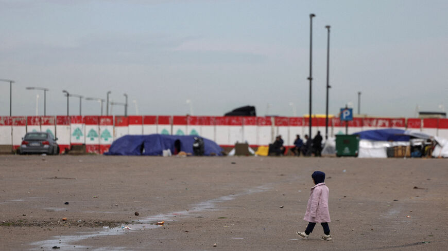 A girl walks at a temporary encampment for displaced people, following an escalation between Hezbollah and Israel, amid the U.S.-Israeli conflict with Iran, in Beirut, Lebanon, March 22, 2026. REUTERS/Khalil Ashawi
