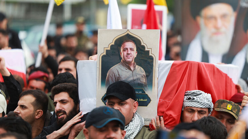 Mourners carry the coffin of Saad al-Baiji, the Popular Mobilisation Forces' Anbar operations commander, who was killed in airstrikes that targeted a PMF site in Iraq's western Anbar province, during his funeral, in Baghdad, Iraq, March 24, 2026. REUTERS/Ahmed Saad