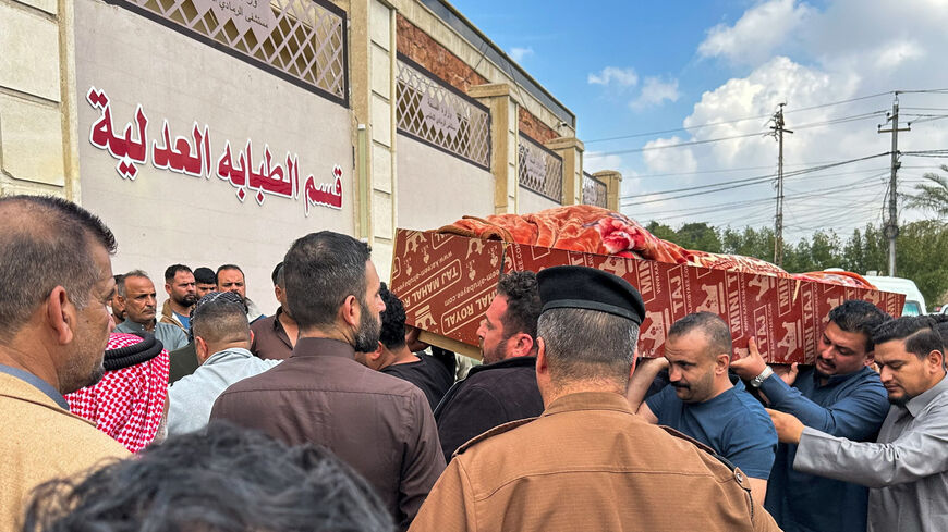 Relatives carry the coffin of an Iraqi soldier killed in an airstrike near an army medical centre in western Anbar, at the forensic medicine department of Ramadi General Hospital, Iraq March 25, 2026. REUTERS/Osama Al-Dulaimi