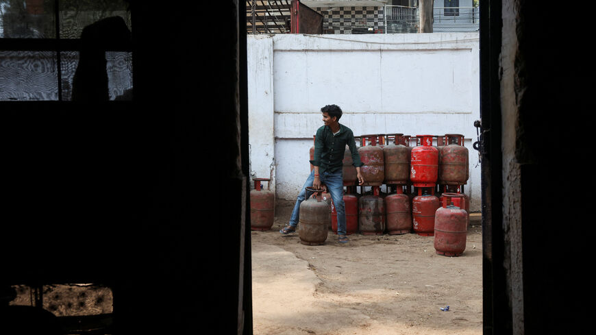 FILE PHOTO: A worker moves an LPG cylinder at a godown, amid supply disruptions following the U.S.-Israeli conflict with Iran, in New Delhi, India, March 10, 2026. REUTERS/Bhawika Chhabra/File Photo