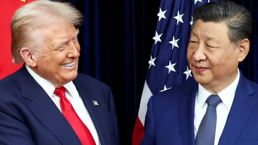 FILE PHOTO: U.S. President Donald Trump and Chinese President Xi Jinping react as they hold a bilateral meeting at Gimhae International Airport, on the sidelines of the Asia-Pacific Economic Cooperation (APEC) summit, in Busan, South Korea, October 30, 2025. REUTERS/Evelyn Hockstein/File Photo
