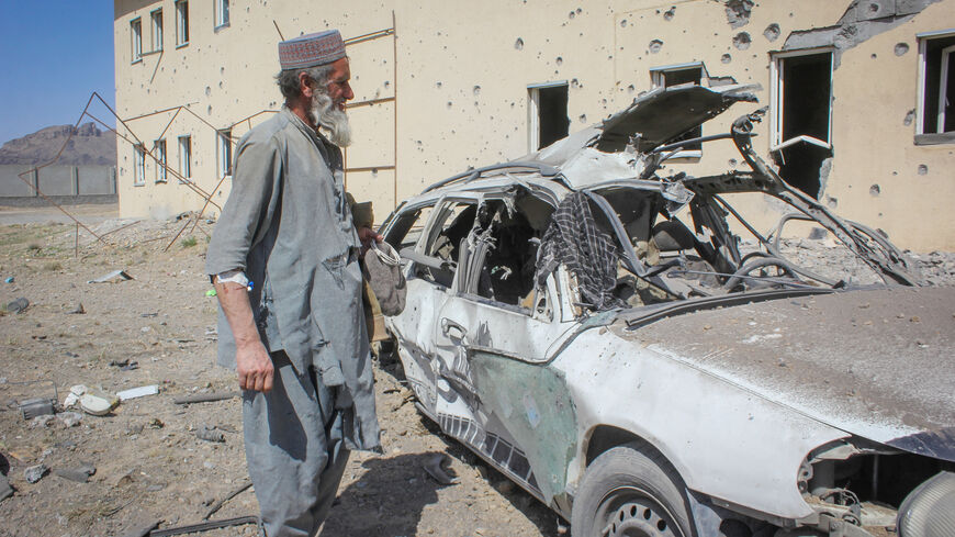 An Afghan man stands next to a damaged car following airstrikes, amid the conflict between Afghanistan and Pakistan, in Kandahar, Afghanistan, February 28, 2026. REUTERS/Stringer