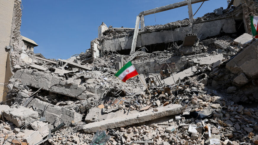 An Iranian flag stands in the rubble following a strike on a police station in Tehran, Iran, March 4.   Majid Asgaripour/WANA