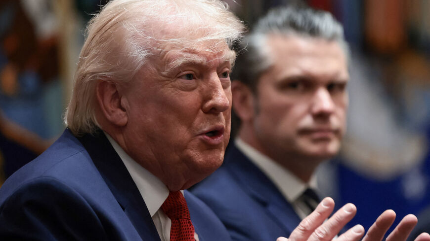 U.S. President Donald Trump speaks next to Defense Secretary Pete Hegseth during a cabinet meeting at the White House in Washington, D.C., U.S., March 26, 2026. REUTERS/Evelyn Hockstein
