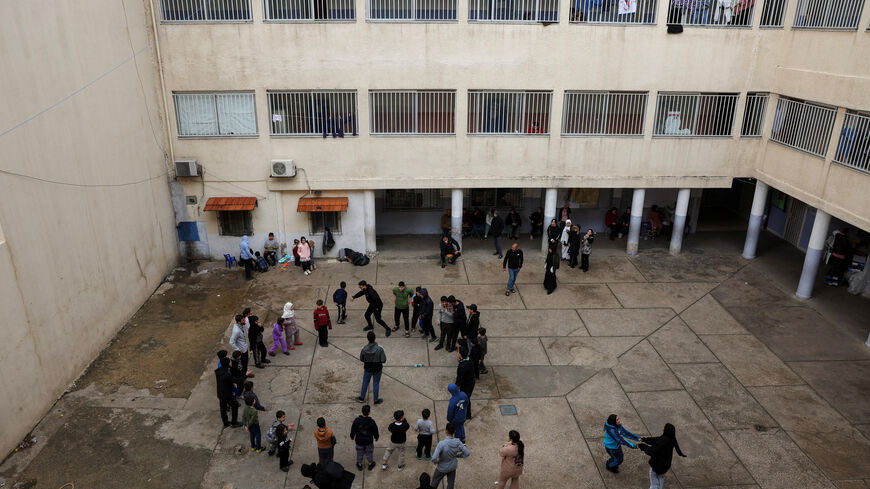 Children play at the yard of a school used as a temporary shelter for displaced people, following an escalation between Hezbollah and Israel, amid the U.S.-Israeli conflict with Iran, in Beirut, Lebanon, March 23, 2026. REUTERS/Mohamed Azakir