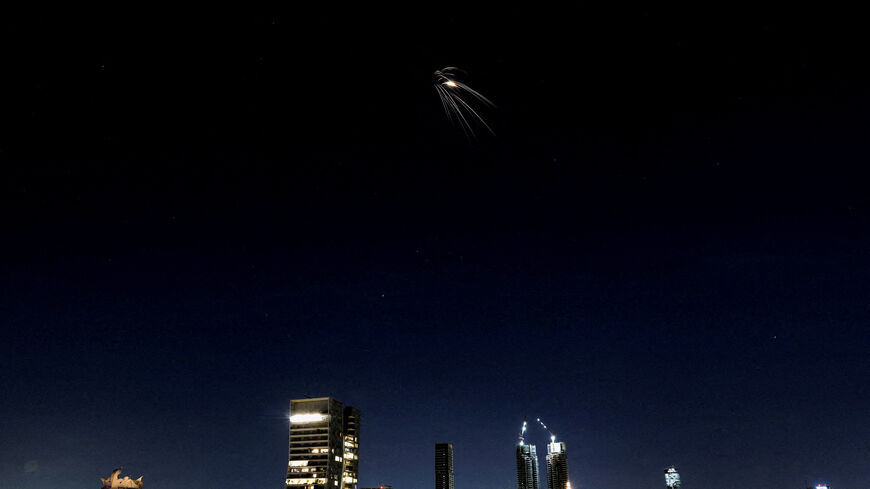 FILE PHOTO: An Iranian missile with cluster warhead flies over the city, amid the U.S.-Israeli conflict with Iran, as seen from Tel Aviv, Israel, March 24, 2026. REUTERS/Ronen Zvulun/File Photo