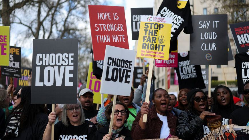 Demonstrators carry placards as they gather prior to a march against far-right extremism from Park Lane to Trafalgar Square, organised by the Together Alliance, a coalition of unions and civil society groups, in London, Britain, March 28, 2026. REUTERS/Hannah McKay