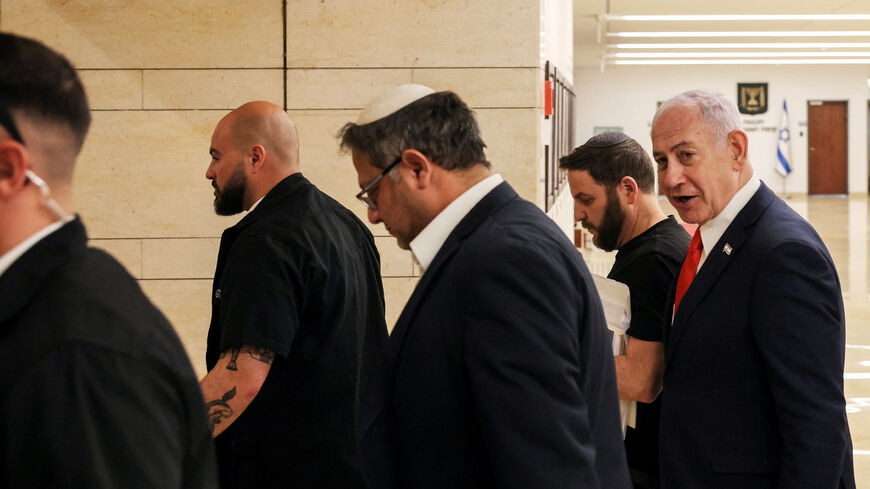 Israeli Prime Minister Benjamin Netanyahu and National Security Minister Itamar Ben-Gvir walk together inside the Knesset in Jerusalem March 27, 2025. REUTERS/Ronen Zvulun