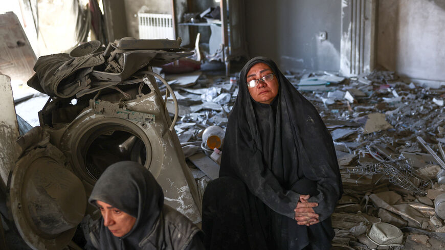 Women sit at a home, which was damaged by a strike, amid the U.S.-Israeli conflict with Iran, in Tehran, Iran, March 30, 2026. Majid Asgaripour/WANA (West Asia News Agency) via REUTERS