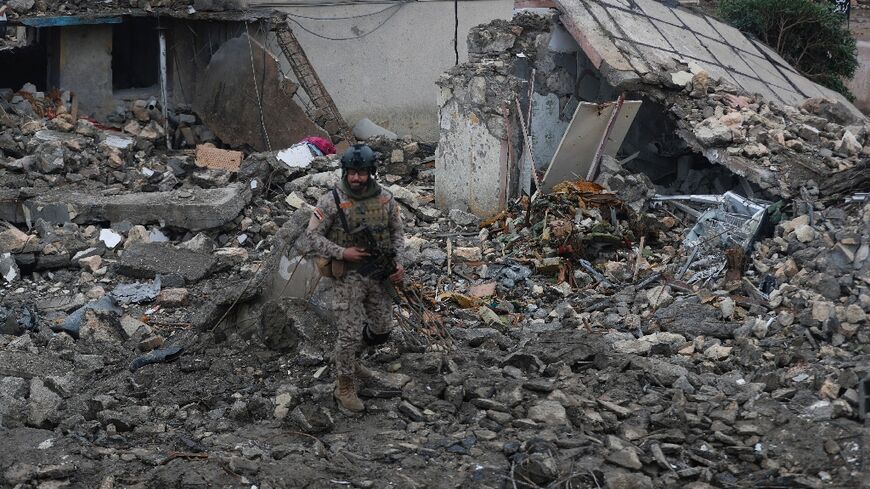 An Iraqi soldier guards the site of the destroyed health centre at the Habbaniyah military base