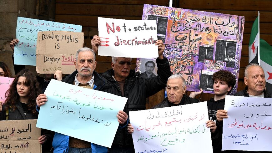 Syrians hold a silent protest against an official decision banning the sale of alcohol outside of certain areas