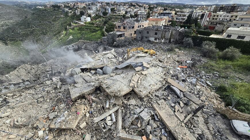First responders work on the rubble of a building targeted by an Israeli airstrike in the southern Lebanese village of Hanouiyeh, east of Tyre