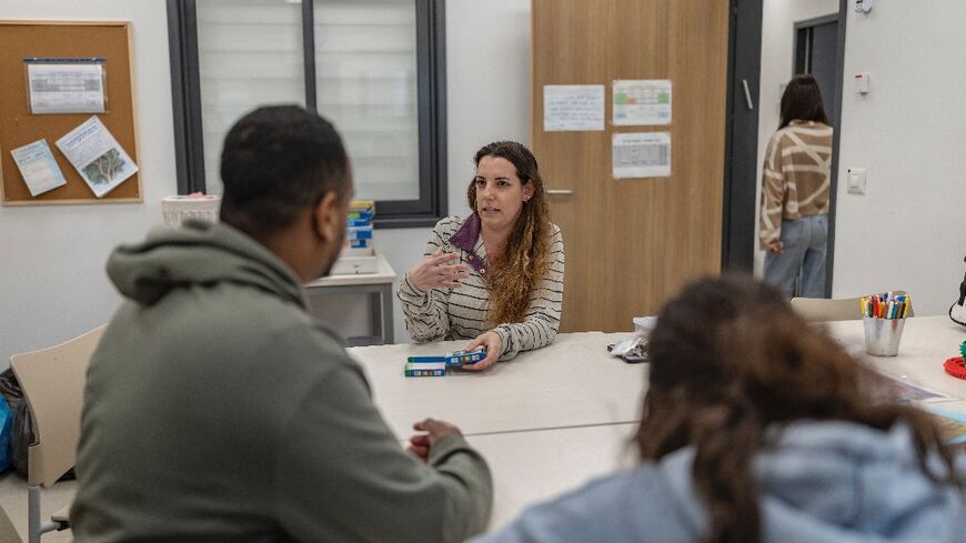 Therapist Shani Volovic Shushan plays cards with patients at the Shalvata Mental Health Centre
