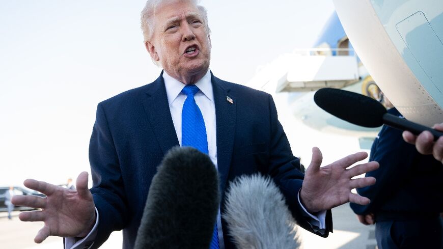 US President Donald Trump speaks to reporters before boarding Air Force One in Florida
