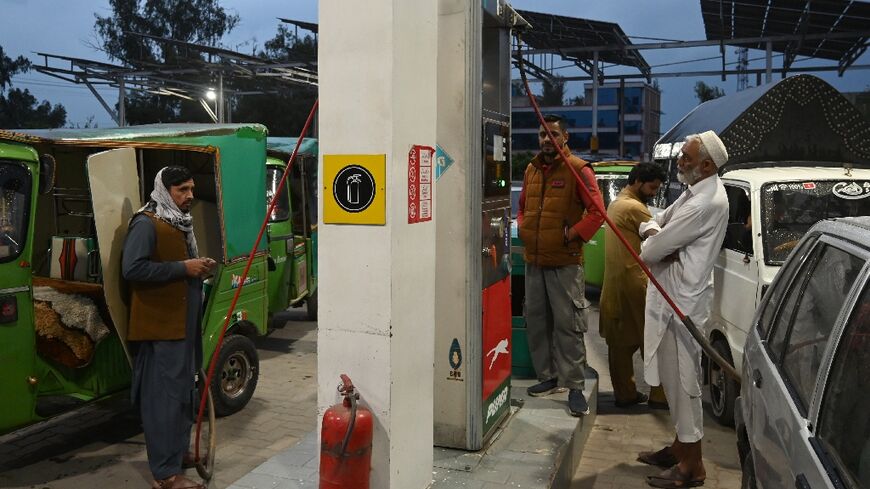 Commuters queue up at a compressed natural gas (CNG) station in Peshawar, in northwestern Pakistan, on March 25, 2026 as oil prices soar due to the US-Israeli war on Iran