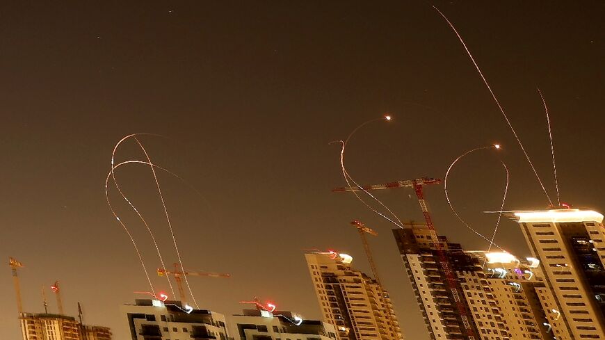Rocket trails are seen in the sky above the Israeli coastal city of Netanya amid a fresh barrage of Iranian missile attacks on Tuesday