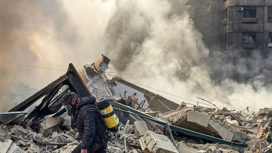 A firefighter inspects the debris after an Israeli air strike in southern Beirut