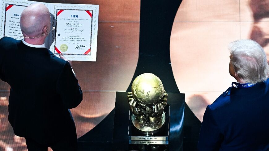 FIFA President Gianni Infantino presents the newly-created FIFA Peace Prize to US President Donald Trump at the World Cup draw