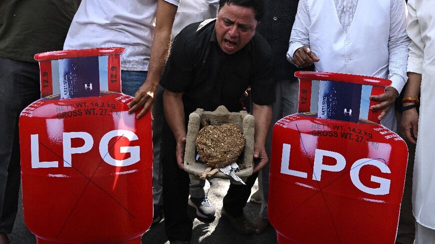 Soaring black market prices of cooking gas in India's capital are pushing poorer families back to wood and coal