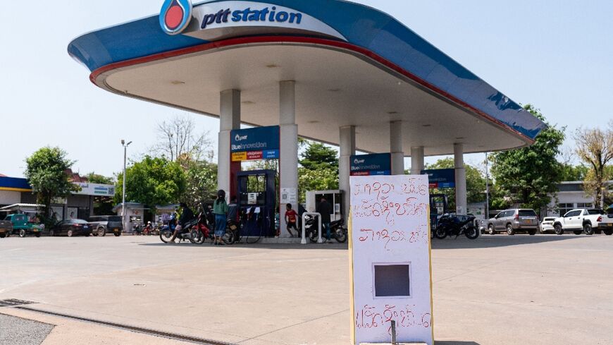 'Diesel run out and gasoline run out' reads a sign at a gas station in Vientiane in Laos on March 10, 2026