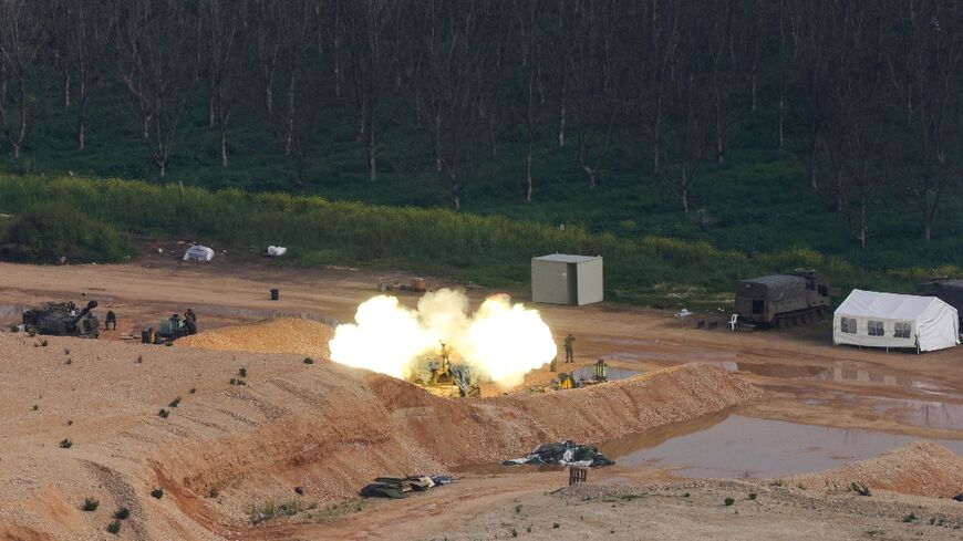 An Israeli self-propelled howitzer fires rounds towards southern Lebanon from a position in northern Israel near the border 