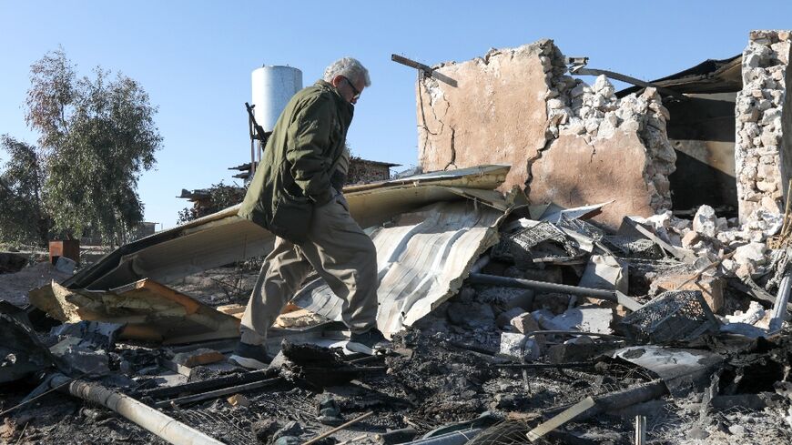 An Iranian Kurdish Peshmerga member of the Kurdistan Democratic Party of Iran inspects the damage sustained at the Azadi Camp following an Iranian cross-border attack in northern Iraq