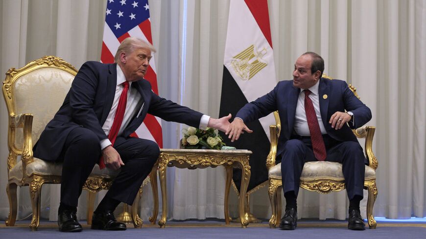 US President Donald Trump and President of Egypt Abdel Fattah El-Sisi clasp hands as they speak to the press before their meeting on Oct. 13, 2025, in Sharm el-Sheikh, Egypt. 