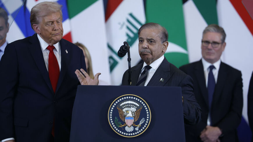 Pakistan's Prime Minister Shehbaz Sharif (C) speaks as US President Donald Trump (L) and Britain's Prime Minister Keir Starmer (R) watch during the Sharm El-Sheikh Peace Summit on Oct. 13, 2025 in Sharm El-Sheikh, Egypt.  