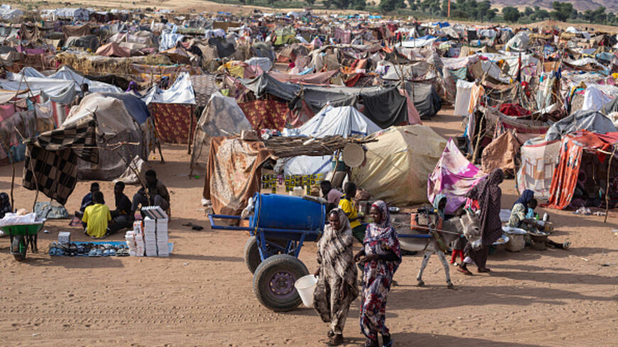 Displaced Sudanese who fled El-Fasher after the city fell to the Rapid Support Forces (RSF), walk in the Um Yanqur camp, located on the southwestern edge of Tawila, in war-torn Sudan's western Darfur region on November 3, 2025. (Photo by AFP) (Photo by -/AFP via Getty Images)