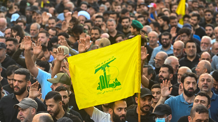 Mourners wave Hezbollah flags during the funeral ceremony of top Hezbollah chief Haytham Ali Tabatabai and other members killed in an Israeli strike in Beirut's southern suburbs on November 24, 2025. 