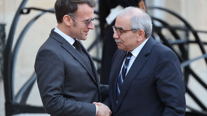 France's President Emmanuel Macron (L) wearing sunglasses shakes hands with Lebanon's Prime Minister Nawaf Salam prior to their meeting at the Elysee presidential palace in Paris, on January 23, 2026. (Photo by Ludovic MARIN / AFP via Getty Images)