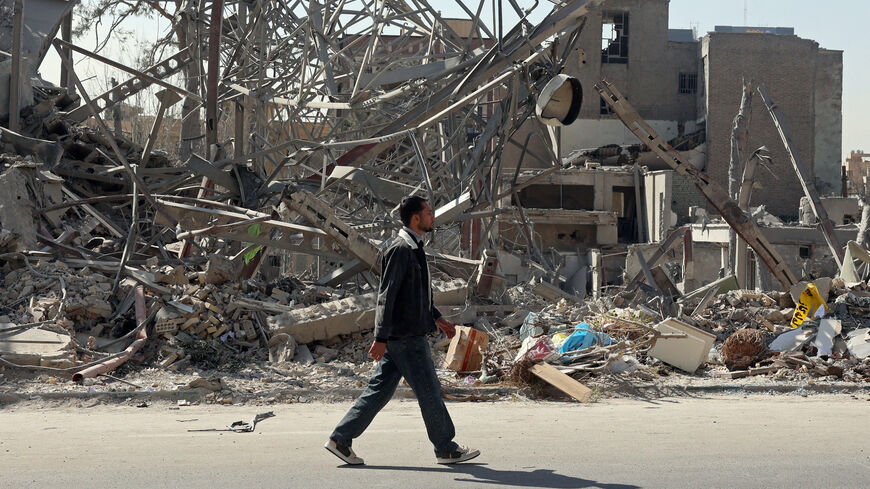 A man walks past destroyed buildings following airstrikes in central Tehran on March 4, 2026. 