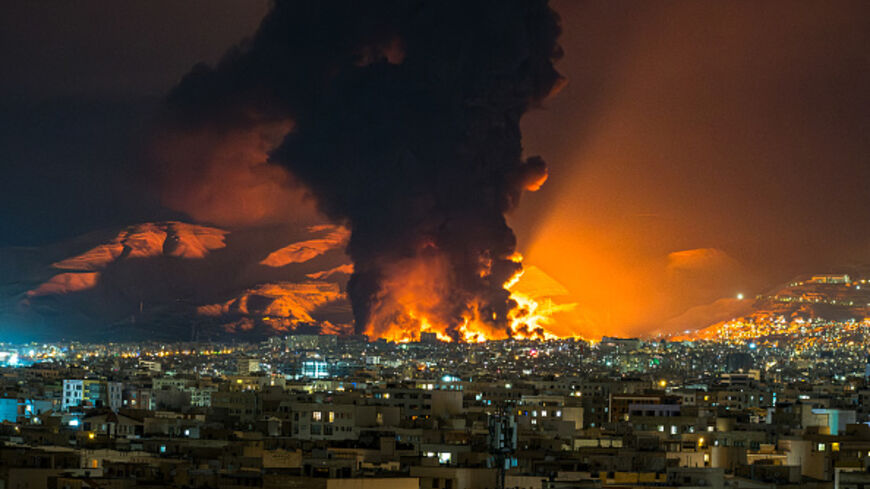 Smoke and flames rise at the site of airstrikes on an oil depot in Tehran on March 7, 2026. (AFP via Getty Images)