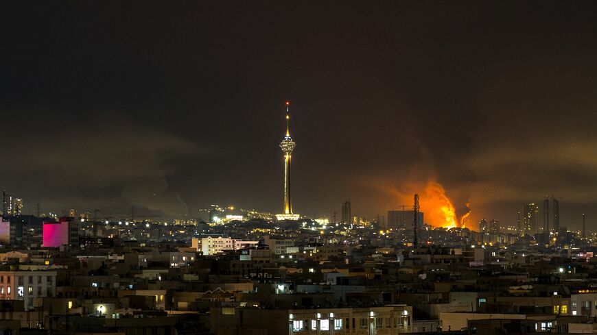 Smoke and flames rise at the site of airstrikes on an oil depot in Tehran on March 7, 2026. 