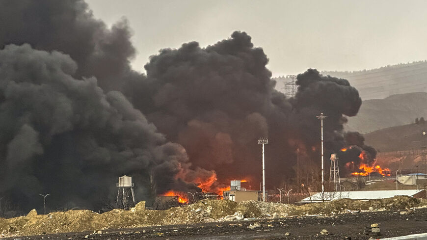 Smoke and flames rise at the site of airstrikes on an oil depot, Tehran, Iran, March 8, 2026.