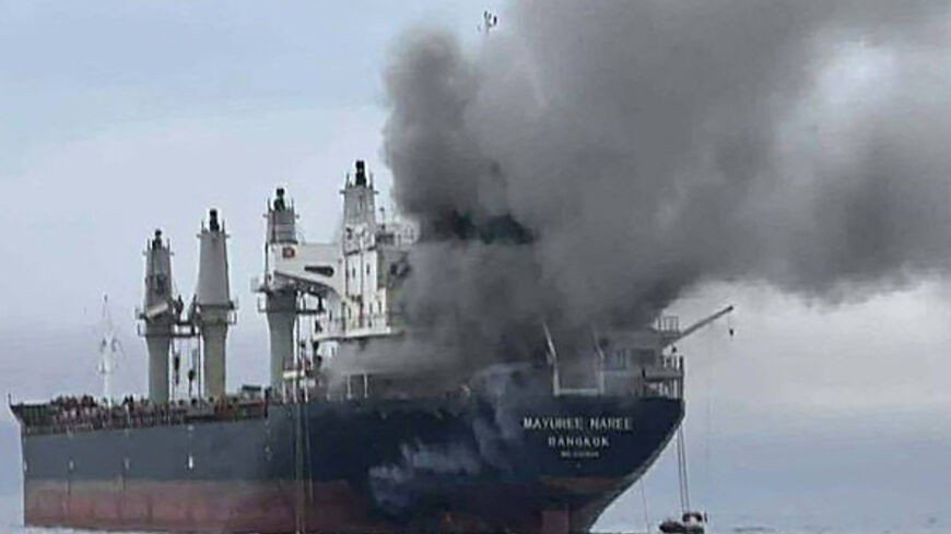 This handout photo taken on March 11, 2026 and released by the Royal Thai Navy shows smoke rising from the Thai bulk carrier 'Mayuree Naree' near the Strait of Hormuz after an attack. A Thai bulk carrier travelling in the crucial Strait of Hormuz was attacked March 11, with 20 crew members rescued so far, the Thai navy said. (Photo by Handout / ROYAL THAI NAVY / AFP via Getty Images) / -----EDITORS NOTE --- RESTRICTED TO EDITORIAL USE - MANDATORY CREDIT "AFP PHOTO / ROYAL THAI NAVY " - NO MARKETING - NO ADV