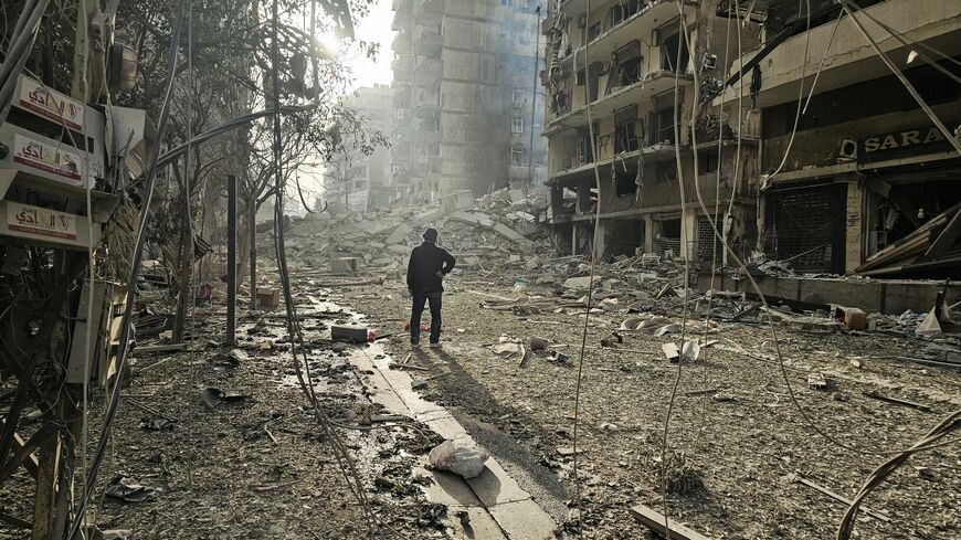 A man looks at the site of overnight Israeli airstrikes in the southern suburbs of Beirut on March 12, 2026. 
