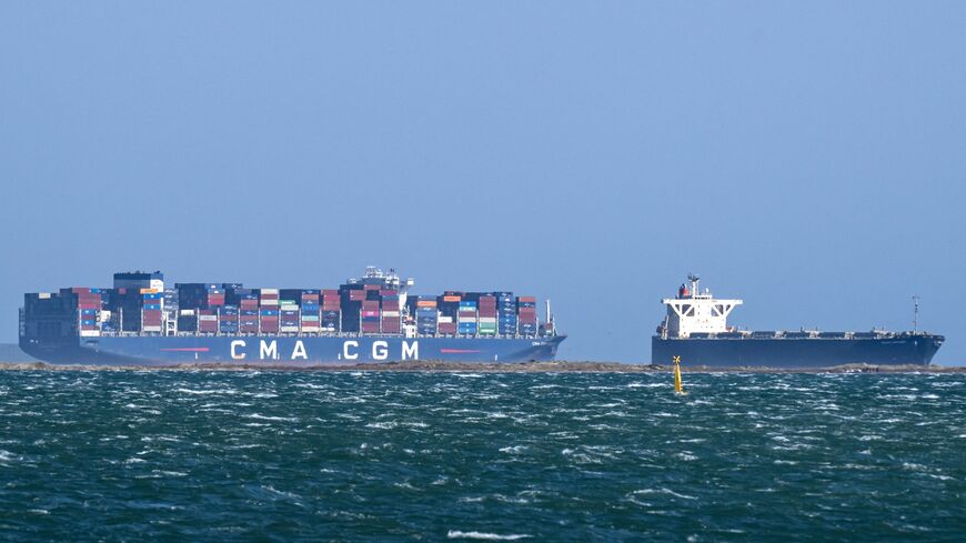 This photograph shows the Malta-flagged container ship CMA CGM "pollon Valletta and the Panamean-flagged Wood Chips carrier Green Sapphire in the sea in Fos-sur-Mer, southern France, on March 25, 2026.
