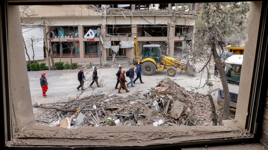 People inspect destruction at a business building that housed the offices of the Doha-headquartered news network Al Araby TV following a missile strike earlier in the day, Tehran, Iran, March 29, 2026.