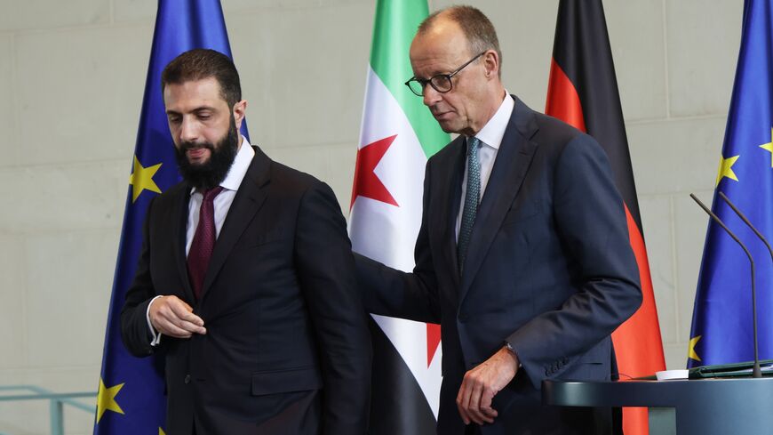German Chancellor Friedrich Merz (R) and Syrian President Ahmed al-Sharaa depart after speaking to the media following talks at the Chancellery on March 30, 2026, in Berlin, Germany.
