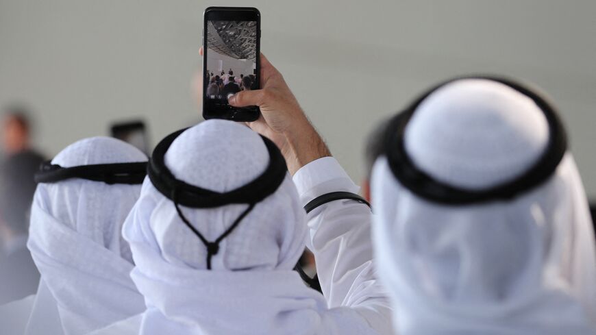 Attendees take a picture of French Prime Minister Edouard Philippe as he delivers a speech during a visit to the Louvre Abu Dhabi Museum on February 10, 2018, on Saadiyat island in the Emirati capital, to launch the French-Emirati "Year of Cultural Dialogue". (Photo by KARIM SAHIB / AFP) (Photo by KARIM SAHIB/AFP via Getty Images)