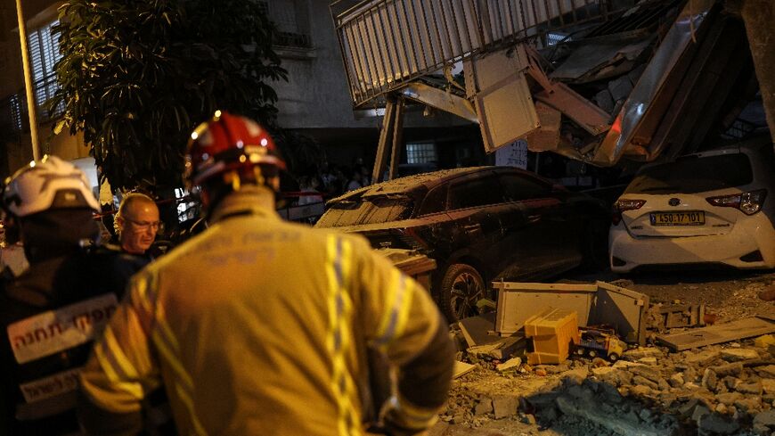 Buildings were damaged and more than 12 people injured following multiple rounds of Iranian missile fire on Israel