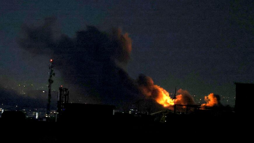 A plume of smoke rises from the site of a strike in Tehran on Monday